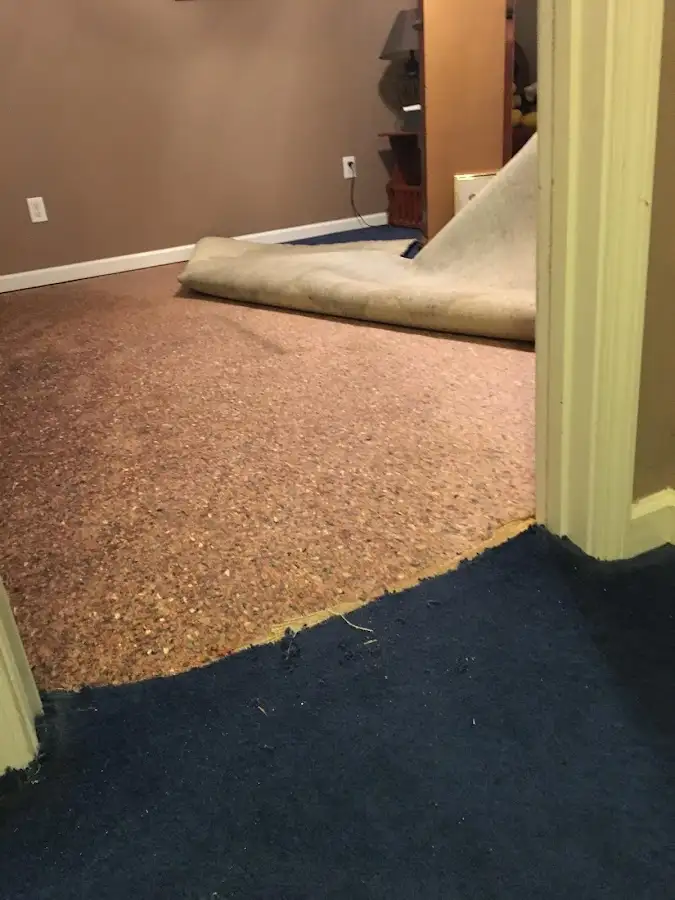 Carpet pad removal revealing water damage during Drying & Dehumidification in Chalmette